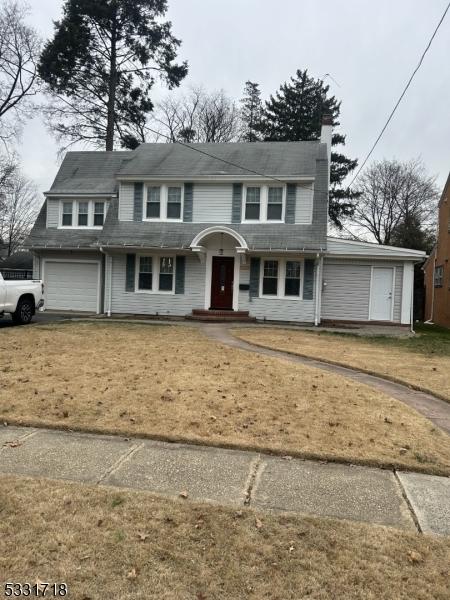 front of property with a front yard and a garage