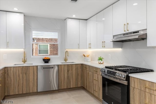 kitchen featuring white cabinets, black range with gas stovetop, stainless steel dishwasher, and sink