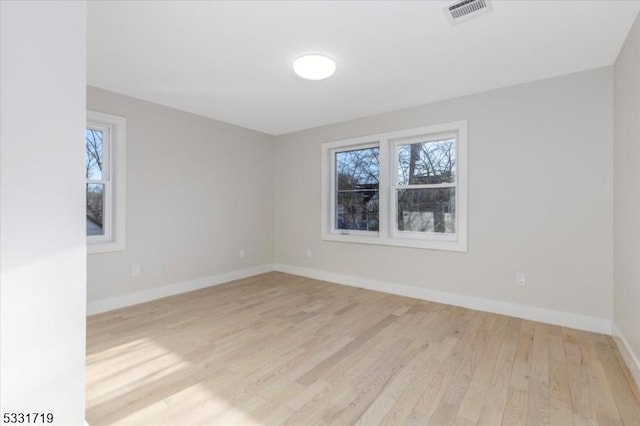 spare room featuring light hardwood / wood-style floors