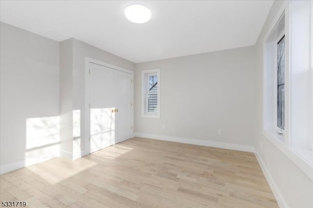 unfurnished room with light wood-type flooring