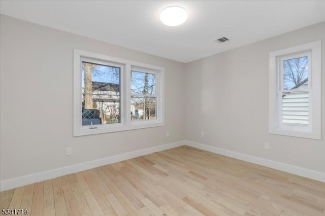 unfurnished room with plenty of natural light and light wood-type flooring