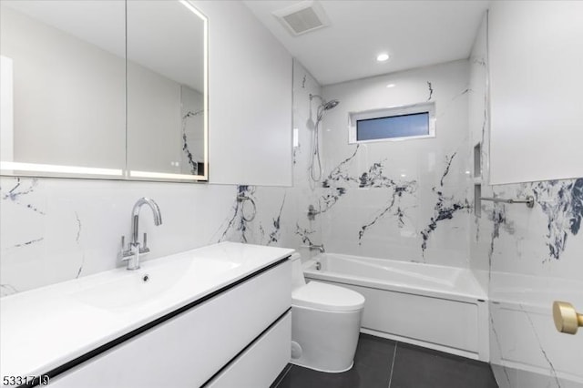 full bathroom with vanity, shower / bath combination, toilet, and tile walls