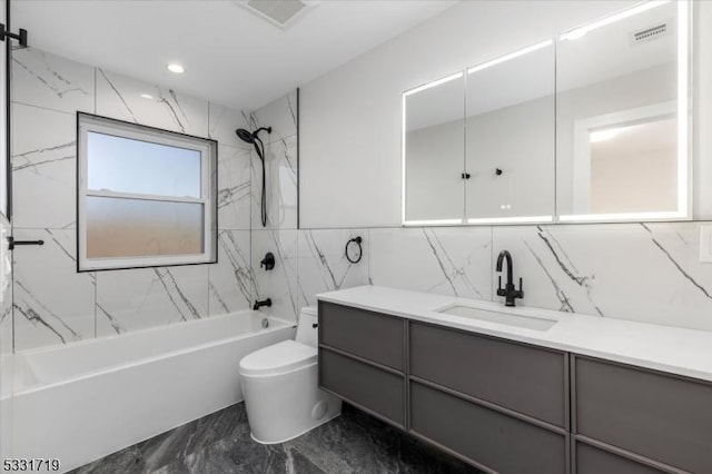 full bathroom featuring tiled shower / bath combo, toilet, and vanity