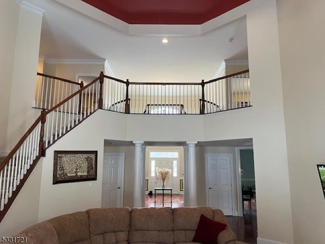 living room featuring decorative columns and ornamental molding