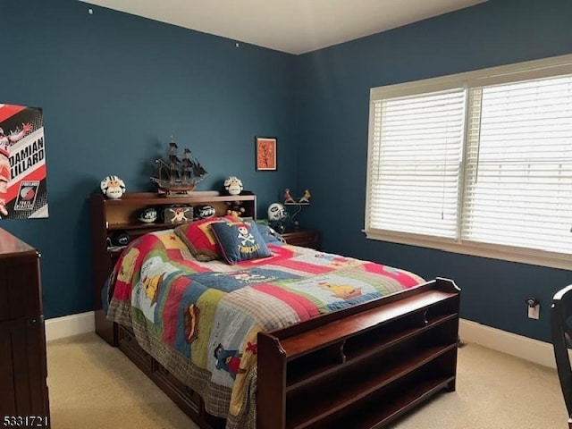 carpeted bedroom featuring multiple windows