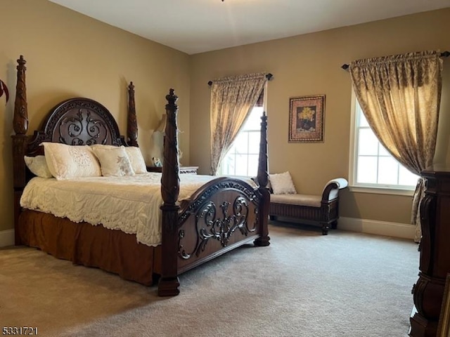 carpeted bedroom featuring multiple windows