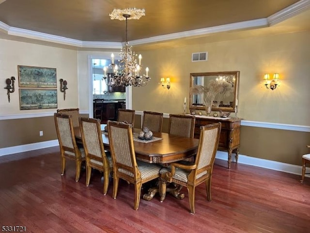 dining space featuring a raised ceiling, crown molding, and dark hardwood / wood-style floors