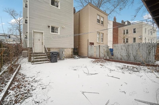 view of snow covered rear of property