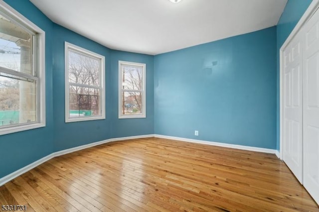 unfurnished room with light hardwood / wood-style flooring