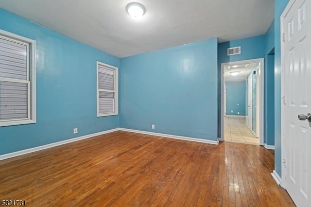 empty room featuring hardwood / wood-style flooring