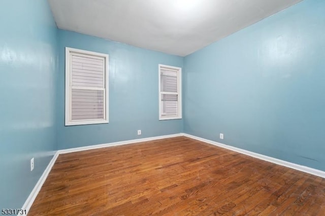 unfurnished room featuring wood-type flooring