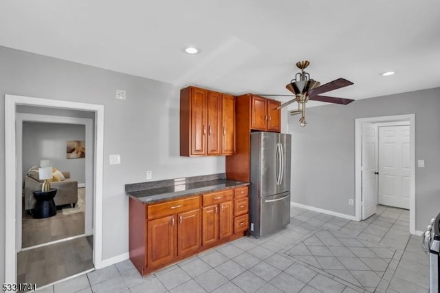 kitchen with ceiling fan, stainless steel fridge, and light tile patterned floors