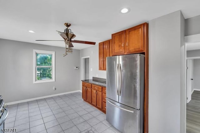 kitchen with stainless steel refrigerator, ceiling fan, and light tile patterned floors