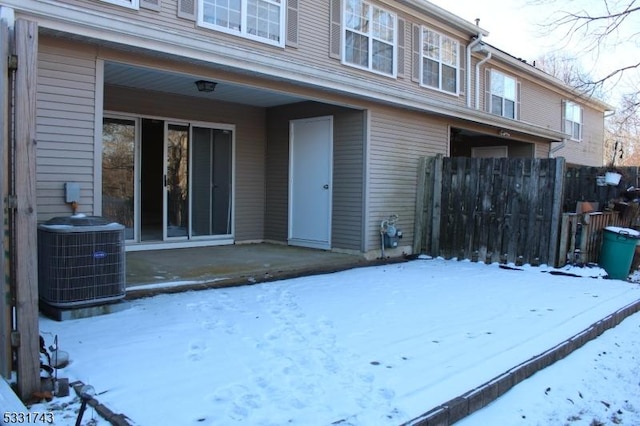 snow covered property featuring central air condition unit