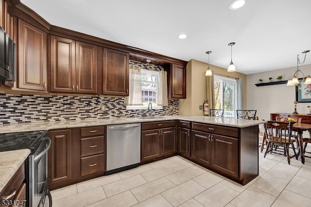 kitchen featuring a peninsula, tasteful backsplash, a sink, light tile patterned floors, and stainless steel appliances