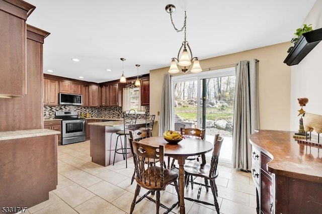 dining area featuring recessed lighting and light tile patterned floors
