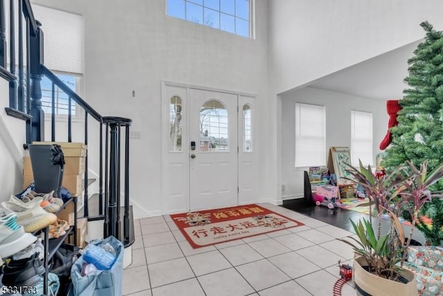 tiled entryway with a high ceiling