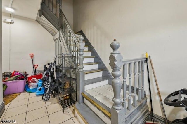 stairs featuring tile patterned flooring