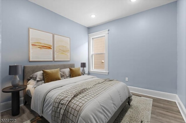 bedroom with dark wood-type flooring