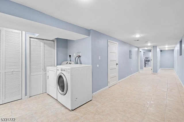 laundry area with light tile patterned floors and independent washer and dryer