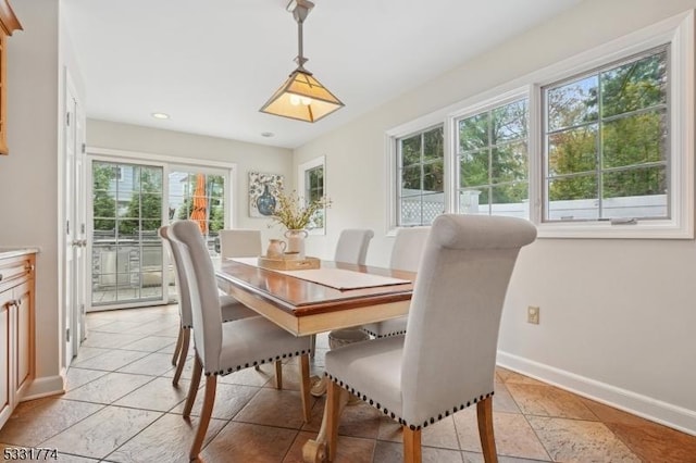 dining room featuring baseboards and recessed lighting