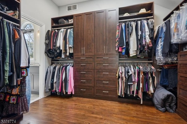 walk in closet with visible vents and wood finished floors