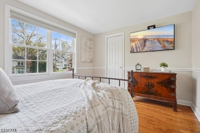 bedroom featuring baseboards, a closet, and wood finished floors
