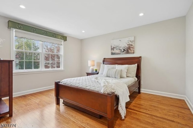 bedroom with baseboards, recessed lighting, and wood finished floors