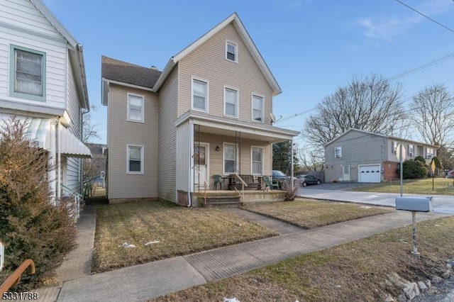 view of property with a front lawn and a porch