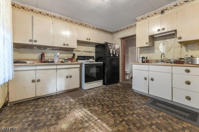 kitchen featuring electric range, black refrigerator, dark parquet flooring, and white cabinetry