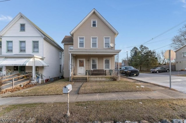 view of front facade with covered porch and a front yard