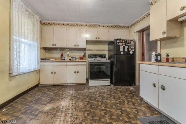 kitchen with white cabinetry, electric stove, black fridge, and dark parquet flooring