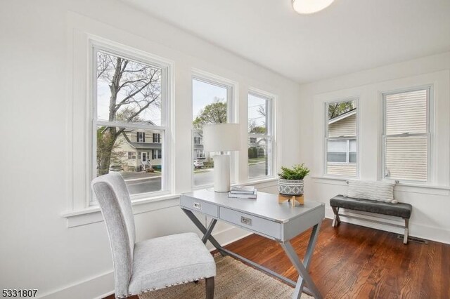 home office featuring baseboards and wood finished floors