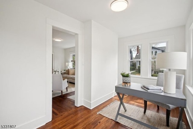 office space featuring a wealth of natural light, baseboards, and wood finished floors