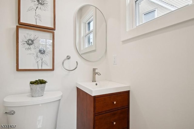 half bath featuring toilet and vanity