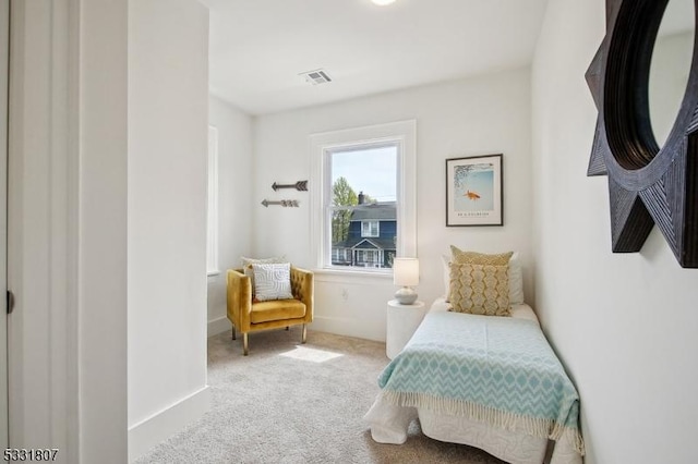 sitting room featuring carpet, visible vents, and baseboards