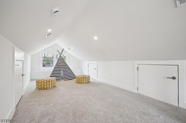 recreation room with lofted ceiling, baseboards, visible vents, and carpet floors