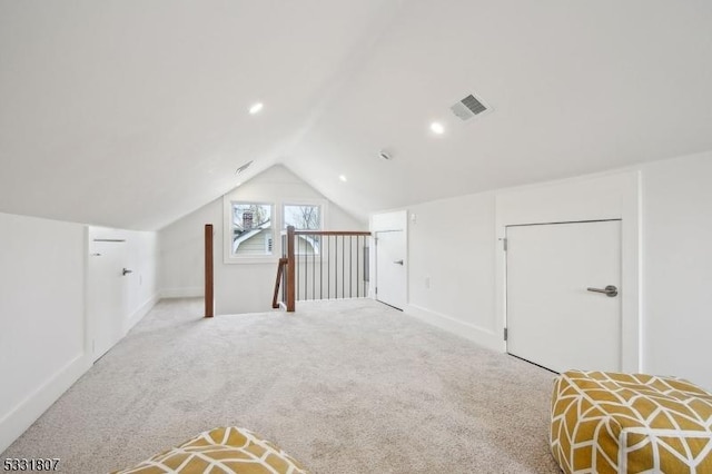 additional living space with vaulted ceiling, light colored carpet, visible vents, and recessed lighting