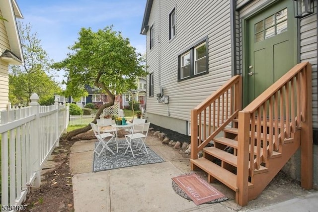view of patio featuring fence and outdoor dining space
