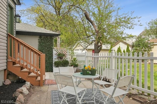 view of patio / terrace with stairway and fence