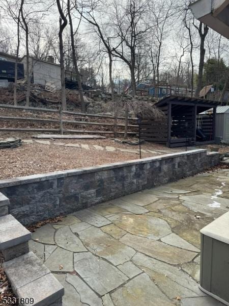 view of patio featuring a storage unit