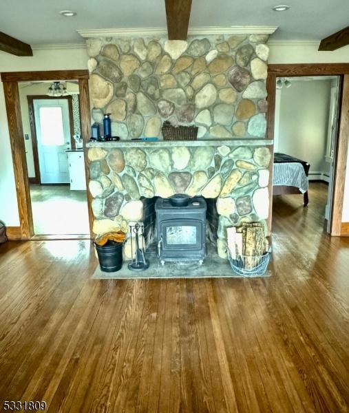 room details with hardwood / wood-style floors and a baseboard heating unit