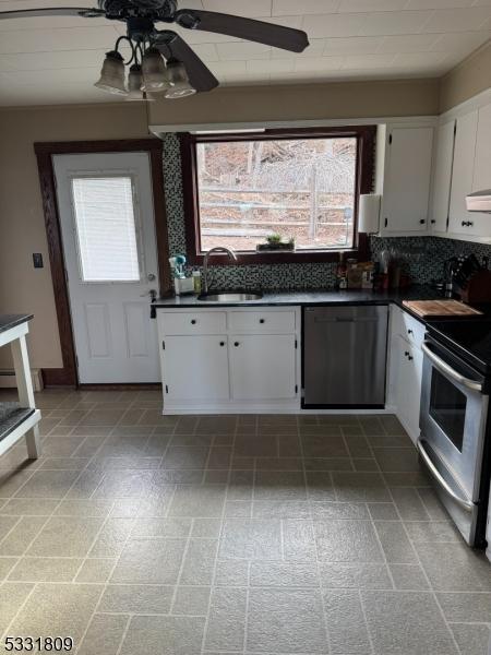 kitchen with decorative backsplash, white cabinetry, ceiling fan, and appliances with stainless steel finishes