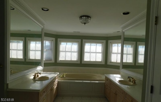 bathroom with tiled tub, vanity, and ornamental molding