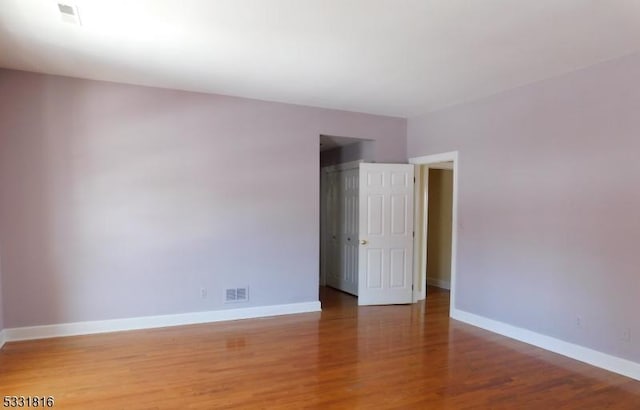 spare room featuring hardwood / wood-style flooring