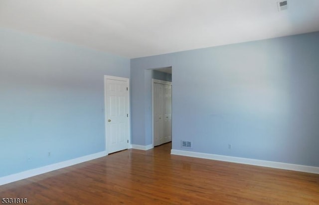 unfurnished room featuring hardwood / wood-style flooring