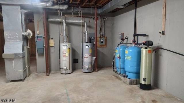 utility room with heating unit and water heater