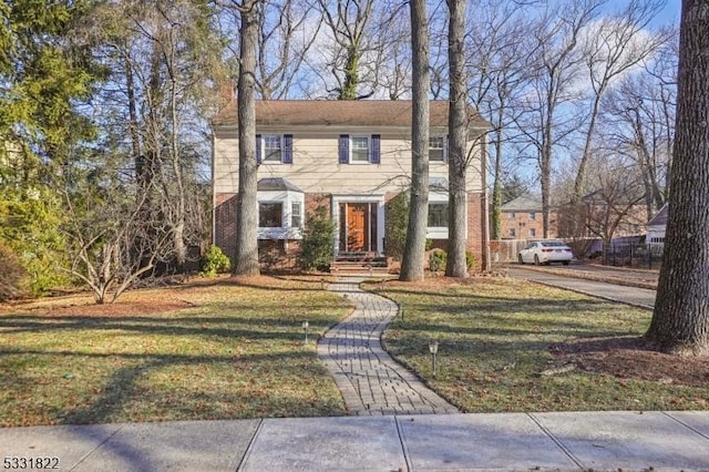 colonial-style house with a front yard