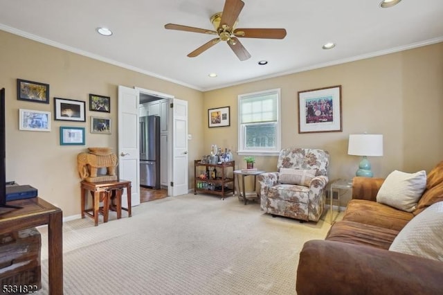 living room featuring ceiling fan, crown molding, and light colored carpet