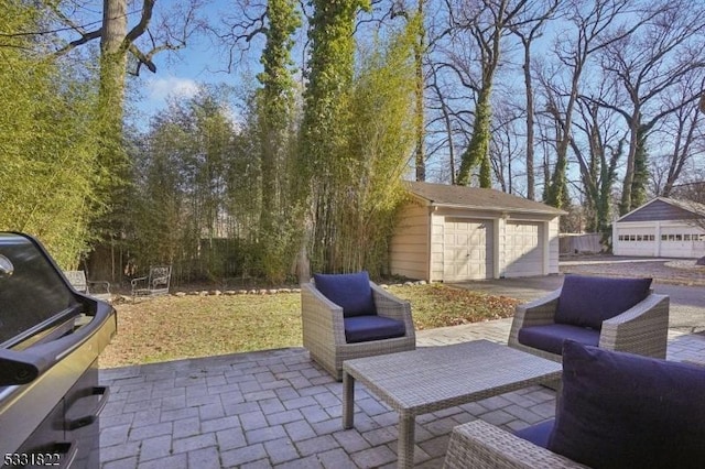 view of patio / terrace with grilling area, an outdoor living space, a garage, and an outdoor structure